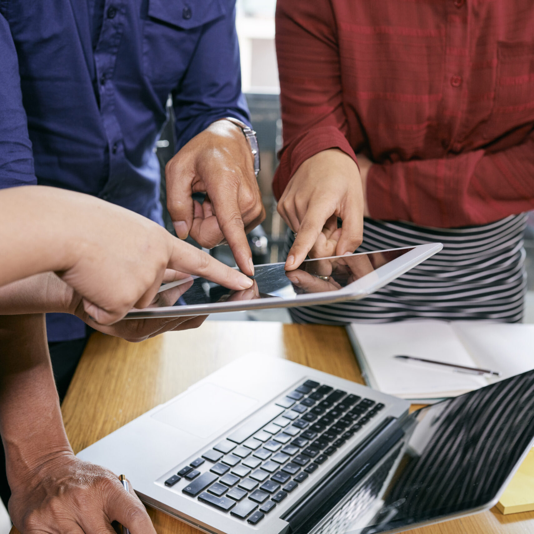 Business people pointing at tablet