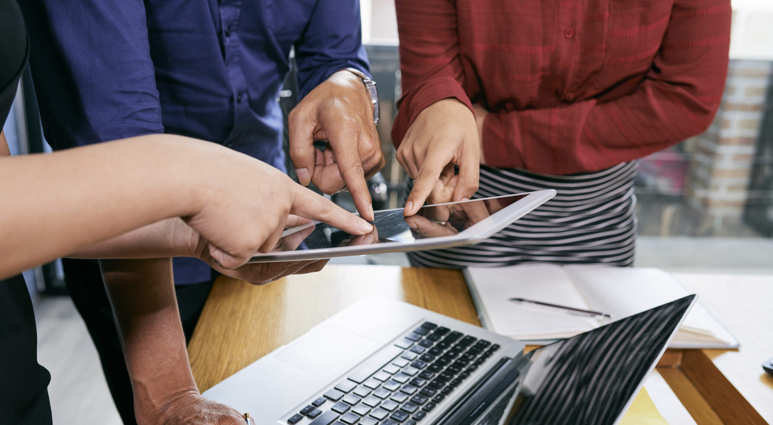 Business people pointing at tablet
